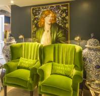 Comfortable green chairs, large pre-Raphaelite paintings and blue/white pots