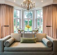 Sofa and picture windows with garden view