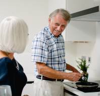Man smiling whilst cooking
