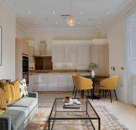 Modern open-plan living room and kitchen with a gray sofa, yellow and patterned cushions, a glass coffee table, dining table with yellow chairs, abstract wall art, and large window.
