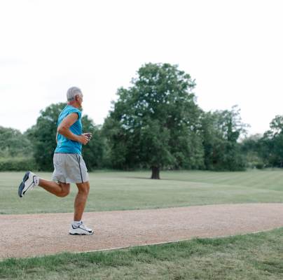 Older man running in park