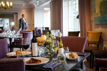 Wine and fine dining in The Lytton restaurant Restaurant table with wine and fine food