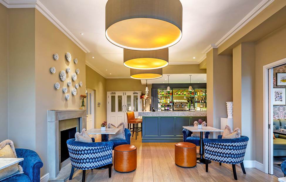 The bistro at Audley Clevedon is both stylish and snug Bistro with blue armchairs, caramel leather stools and beige walls