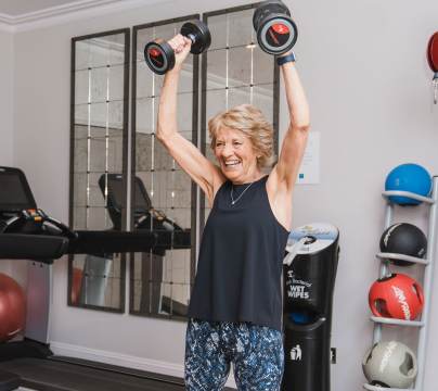 Owner working out in the gym at Audley Redwood