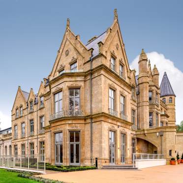 Exterior of a palatial building and green lawn