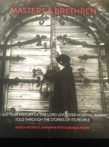 Cover of "Masters & Brethren" depicting a person in historical clothing facing a large, old wooden door. Text reads, "The 450-year history of the Lord Leycester Hospital Warwick.